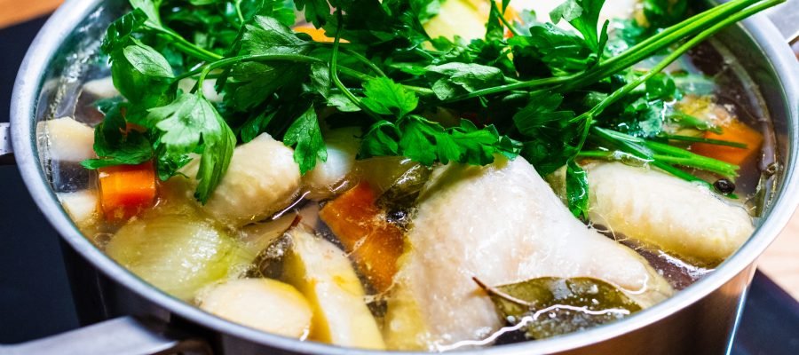Broth - boiling chicken soup in pot